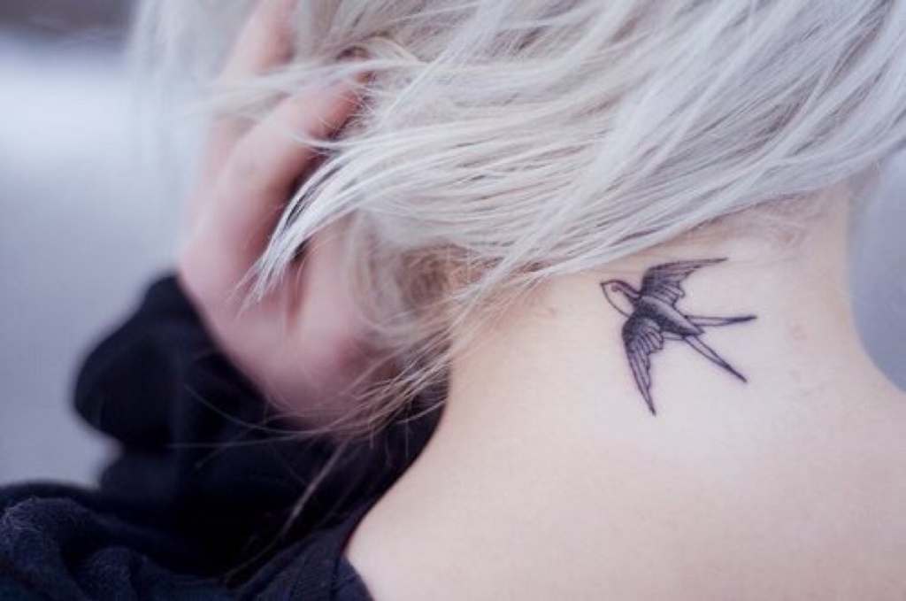 Black Flying Swallow Tattoo On Girl Back Neck