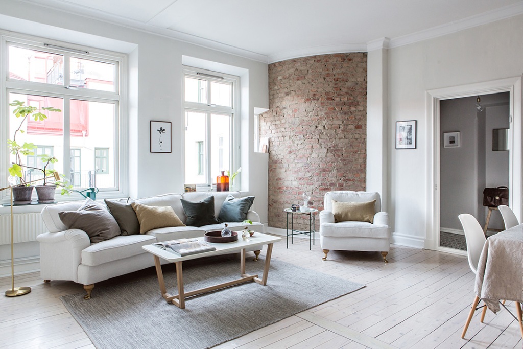 A Bright Interior Design Apartment With One Round Brick Wall