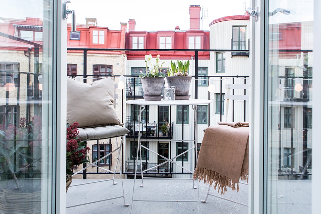 sweet balcony with flower pot and two chair