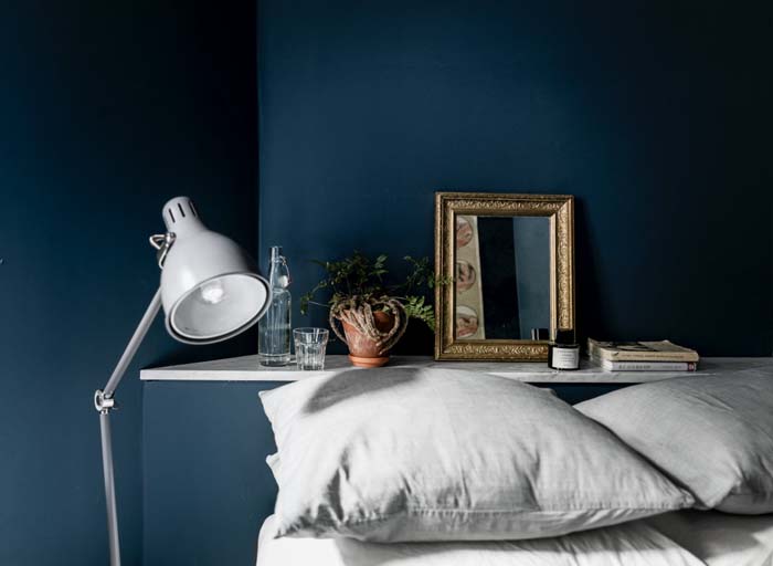 deep blue wall bedroom gray bedding