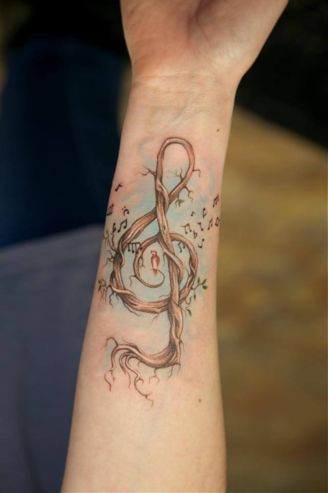 Arm Tattoo Timbered Treble Clef With Bird