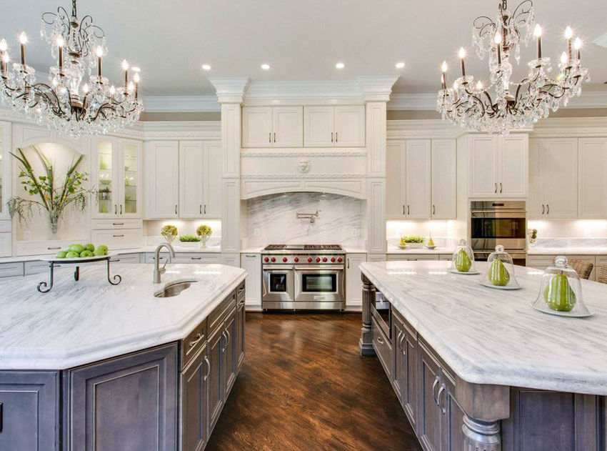 White Cabinets Two Islands and Chandeliers Marble Countertops