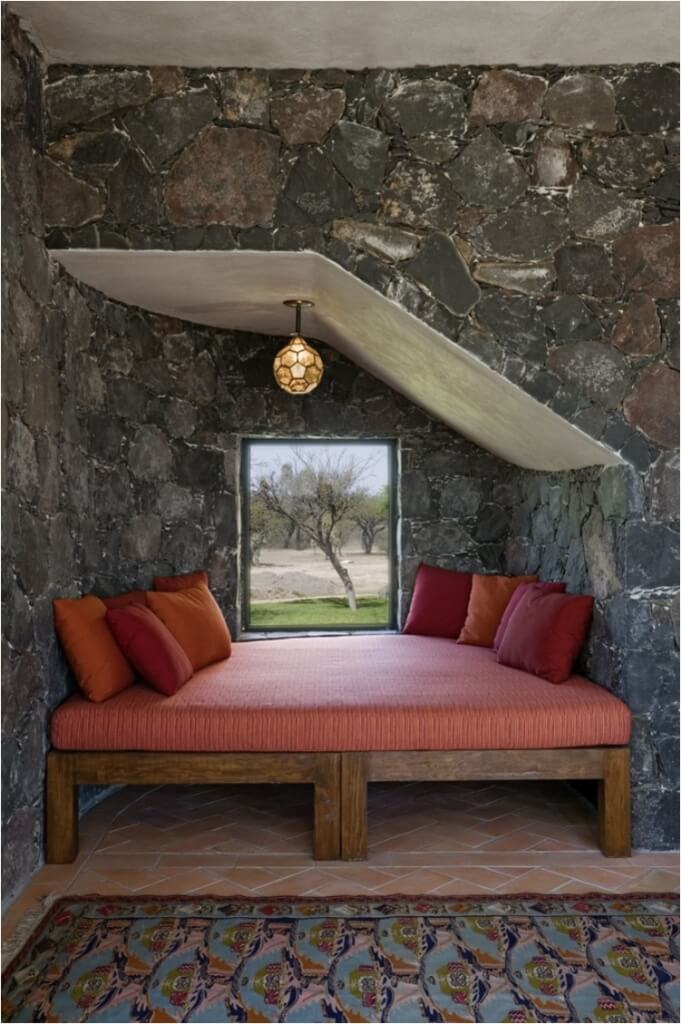 alcove bed with stone walls and pendant light