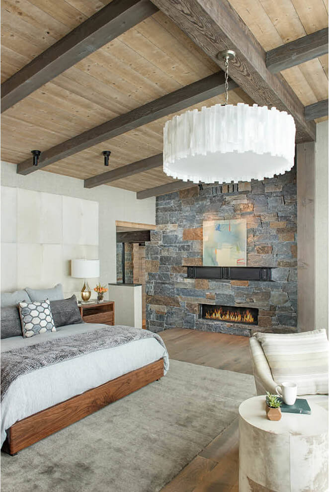 Stone Wall Fireplace In Rustic Bedroom